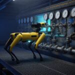 Quadruped inspection robot facing analog pressure gauges in an industrial facility