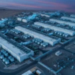 Aerial view of a remote data center campus at dusk, AI-generated illustration