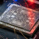 Silicon die on a dark circuit board in red and blue light, AI-generated illustration